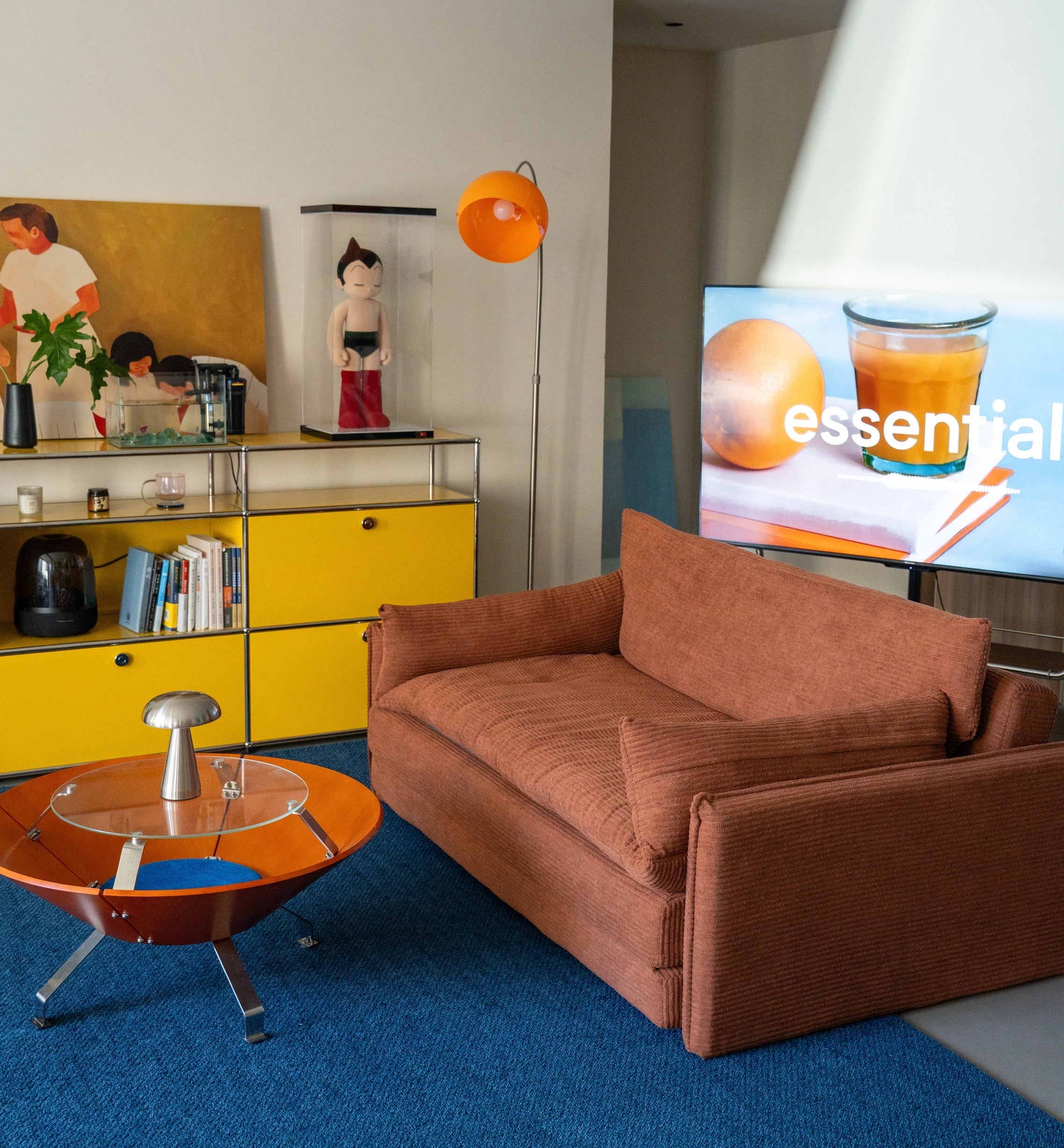 Modern living room with a brown sofa, a yellow cabinet